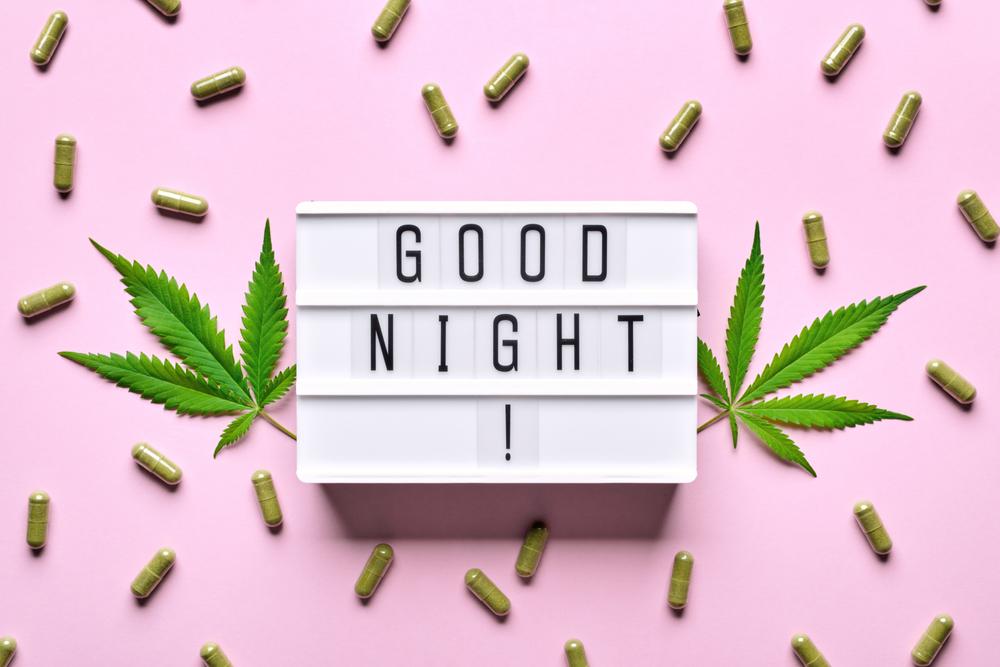 Cannabis extract capsules, hemp leaves and GOOD NIGHT letters lightbox